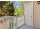 Balcony with white railing and view of wooded area and parking lot at 221 Ashford Cir, Atlanta, GA 30338