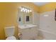 Bathroom featuring a vanity, toilet, shower and bright yellow walls at 221 Ashford Cir, Atlanta, GA 30338