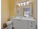 Bright bathroom featuring a vanity with white cabinets and a large mirror at 221 Ashford Cir, Atlanta, GA 30338