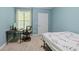 Bedroom with desk, chair, bed with flower patterned bedspread, and blue walls at 221 Ashford Cir, Atlanta, GA 30338