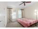 Bedroom featuring two windows with floral curtains and a ceiling fan at 221 Ashford Cir, Atlanta, GA 30338
