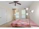 Bedroom featuring two windows with floral curtains and a ceiling fan at 221 Ashford Cir, Atlanta, GA 30338
