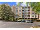 Charming condo building with multiple floors, white balconies, and convenient parking at 221 Ashford Cir, Atlanta, GA 30338