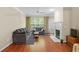 Bright living room features hardwood floors, a fireplace, and large windows for ample natural light at 221 Ashford Cir, Atlanta, GA 30338