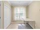 Bright office space featuring a window, white desk, and closet at 221 Ashford Cir, Atlanta, GA 30338