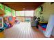 Cozy covered back porch features wood floors, comfortable seating, and plenty of room for relaxation and play at 2568 Morning Glory Pl, Lawrenceville, GA 30044