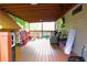 Cozy covered back porch features wood floors, comfortable seating, and plenty of room for relaxation and play at 2568 Morning Glory Pl, Lawrenceville, GA 30044