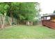 Expansive backyard with green lawn, mature trees, and deck, creating a serene and private outdoor oasis at 2568 Morning Glory Pl, Lawrenceville, GA 30044