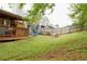 Expansive backyard with green lawn, mature trees, and deck, creating a serene and private outdoor oasis at 2568 Morning Glory Pl, Lawrenceville, GA 30044
