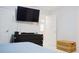 Well lit bedroom with flat screen TV, door to ensuite, woven chest, and modern décor at 2568 Morning Glory Pl, Lawrenceville, GA 30044