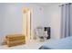 Bright bedroom featuring double doors, ensuite, gliding chair, woven chest, and a small refrigerator at 2568 Morning Glory Pl, Lawrenceville, GA 30044