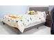 Bright bedroom featuring a themed bedspread, gray headboard, and dinosaur stuffed animals at 2568 Morning Glory Pl, Lawrenceville, GA 30044