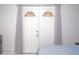 Bright bedroom with double doors and light grey curtains on either side offering elegance and ample natural light at 2568 Morning Glory Pl, Lawrenceville, GA 30044