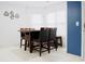 Dining room featuring dark wood table with chairs and a decorative coffee cup decal at 2568 Morning Glory Pl, Lawrenceville, GA 30044