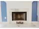 Close-up of a fireplace with marble surround and hearth with decorative elements at 2568 Morning Glory Pl, Lawrenceville, GA 30044