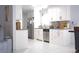 Updated kitchen with white cabinets, stainless steel appliances, and tile flooring at 2568 Morning Glory Pl, Lawrenceville, GA 30044