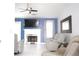 Spacious living room featuring a fireplace, large TV, and modern decor at 2568 Morning Glory Pl, Lawrenceville, GA 30044