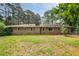 A spacious backyard of brick home with mature trees at 2729 Lanier Dr, Snellville, GA 30078