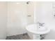 Compact bathroom featuring a pedestal sink, tile shower, and simple fixtures, maximizing functionality in a small space at 2729 Lanier Dr, Snellville, GA 30078