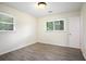 Cozy bedroom with hardwood flooring, natural light, and a view of the surrounding greenery, offering a peaceful retreat at 2729 Lanier Dr, Snellville, GA 30078