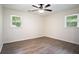 Bright bedroom with hardwood floors, two windows, and neutral walls, creating a serene atmosphere at 2729 Lanier Dr, Snellville, GA 30078