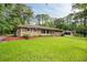 Beautiful brick home with a lush green lawn, landscaping, and a detached garage at 2729 Lanier Dr, Snellville, GA 30078