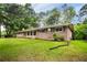 Well-maintained brick home with green lawn and mature trees, side view at 2729 Lanier Dr, Snellville, GA 30078
