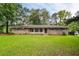 Charming brick ranch-style home with a well-manicured lawn and mature trees at 2729 Lanier Dr, Snellville, GA 30078