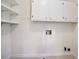 Functional laundry room with white cabinets and shelving for ample storage, ready for appliances at 2729 Lanier Dr, Snellville, GA 30078