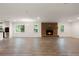 Sunlit living room with a brick fireplace and new flooring at 2729 Lanier Dr, Snellville, GA 30078
