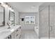 Large bathroom featuring a double sink vanity, tub, and glass shower at 3493 Monarch Ave, Duluth, GA 30096
