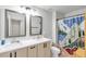 Bathroom with dual vanity, framed mirrors, and a decorative shower curtain at 3493 Monarch Ave, Duluth, GA 30096