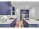 Spacious kitchen features a large island with seating, stainless appliances, marble countertops, and blue cabinets at 3493 Monarch Ave, Duluth, GA 30096