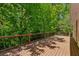 Wooden deck surrounded by lush trees, offering privacy and an excellent space for outdoor enjoyment at 3672 Haddon Hall Rd, Atlanta, GA 30327