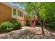 Multi-level backyard featuring a brick patio, deck, and lush greenery, creating a private and serene outdoor space at 3672 Haddon Hall Rd, Atlanta, GA 30327