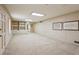 Spacious carpeted basement with recessed lighting and built-in shelving for storage at 3672 Haddon Hall Rd, Atlanta, GA 30327