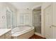Bright bathroom with a large soaking tub, enclosed shower, and modern fixtures creating a relaxing retreat at 3672 Haddon Hall Rd, Atlanta, GA 30327