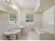 Bright bathroom featuring dual sinks, tiled walls, and a separate soaking tub for a relaxing retreat at 3672 Haddon Hall Rd, Atlanta, GA 30327