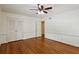 Comfortable bedroom with hardwood flooring, ceiling fan, and ample closet space at 3672 Haddon Hall Rd, Atlanta, GA 30327