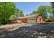Charming brick home with an attached two-car garage, sunroom, and large driveway, surrounded by mature trees at 3672 Haddon Hall Rd, Atlanta, GA 30327
