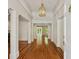 Inviting foyer with beautiful hardwood floors, white columns, trim and elegant light fixture at 3672 Haddon Hall Rd, Atlanta, GA 30327