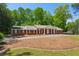 Lovely brick home with manicured lawn and a covered front entrance with white pillars at 3672 Haddon Hall Rd, Atlanta, GA 30327