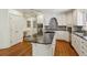 Kitchen with island cooktop, hardwood floors, and stainless steel appliances at 3672 Haddon Hall Rd, Atlanta, GA 30327