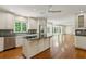 Open-concept kitchen with granite counters, stainless appliances, and hardwood floors at 3672 Haddon Hall Rd, Atlanta, GA 30327