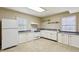 Functional kitchen with white cabinetry, appliances, and ample counter space for meal preparation at 3672 Haddon Hall Rd, Atlanta, GA 30327