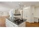 Kitchen with island cooktop, white cabinets, and adjacent living spaces at 3672 Haddon Hall Rd, Atlanta, GA 30327