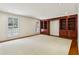 Large living room with custom built-in bookshelves and plenty of natural light from large windows at 3672 Haddon Hall Rd, Atlanta, GA 30327