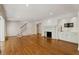 Cozy living room with hardwood floors, fireplace, and staircase access at 3672 Haddon Hall Rd, Atlanta, GA 30327