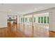 Open-concept living room with hardwood floors, columns, and an adjacent kitchen at 3672 Haddon Hall Rd, Atlanta, GA 30327