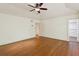 Hardwood floor and large ceiling fan highlight the spacious main bedroom's simple, elegant design at 3672 Haddon Hall Rd, Atlanta, GA 30327